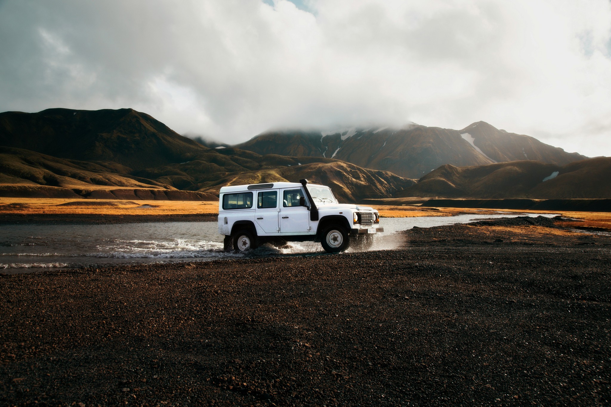 Car crossing a river in the Icelandic Highlands.