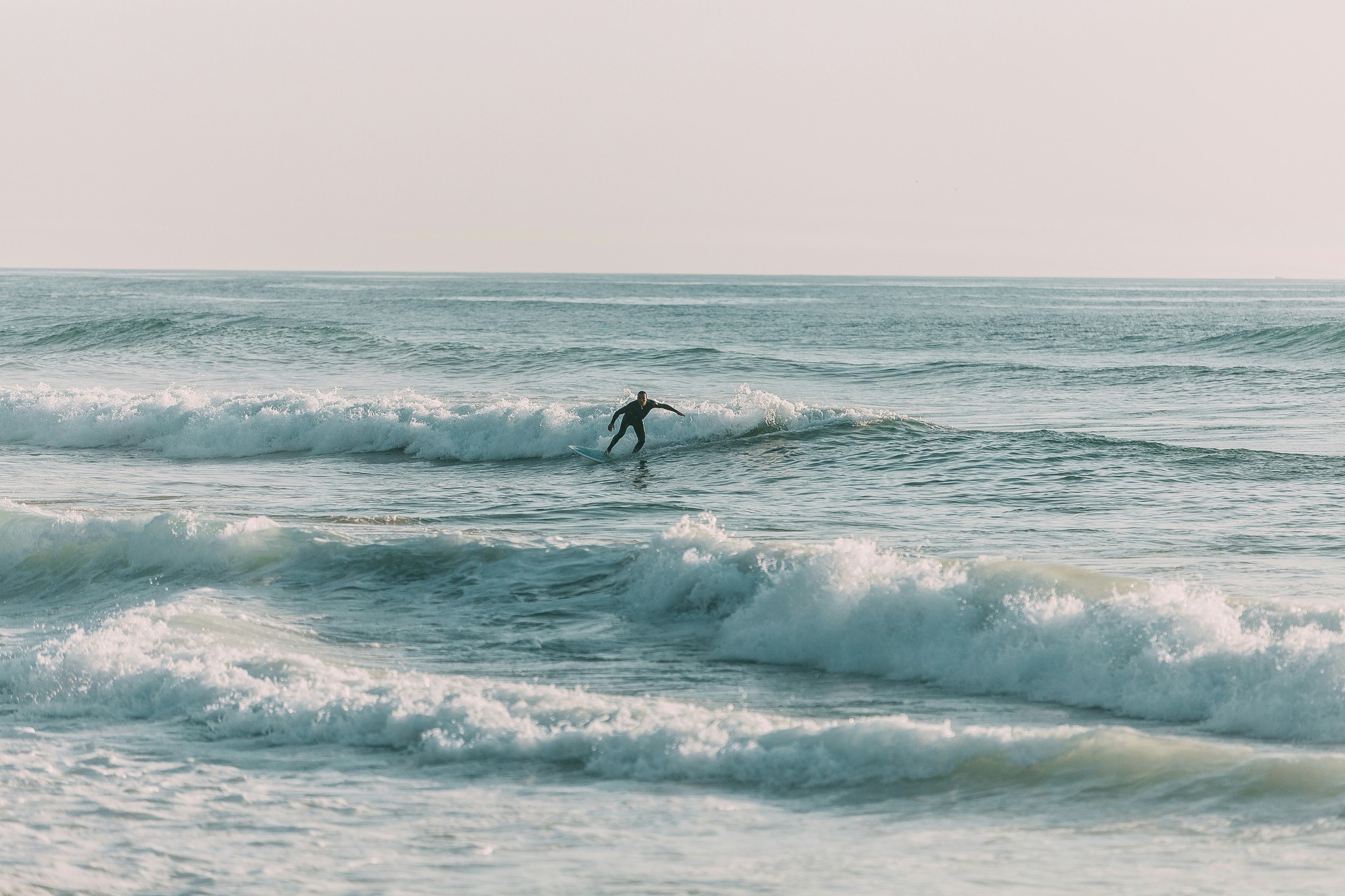 Surfer riding a wave in the open ocean.