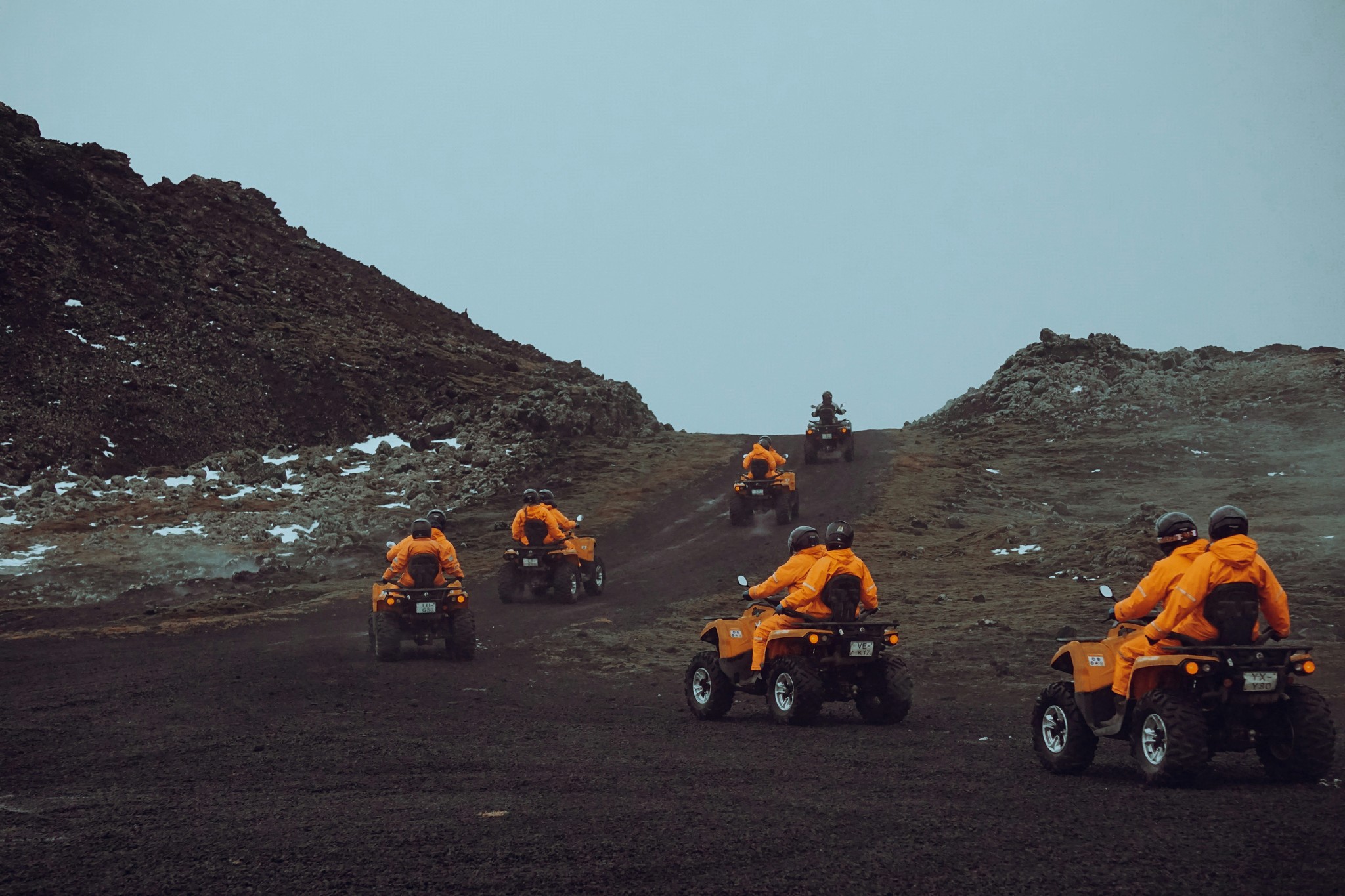 Travelers riding ATVs across volcanic landscapes in Ölfus.
