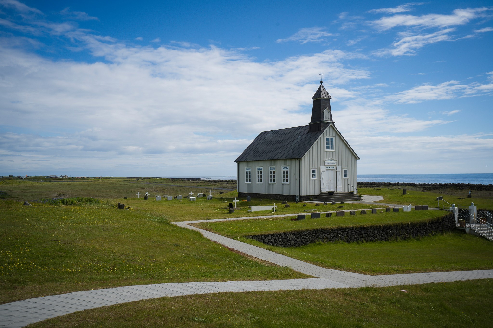 Strandarkirkja in a grassy field in Ölfus, South Iceland.