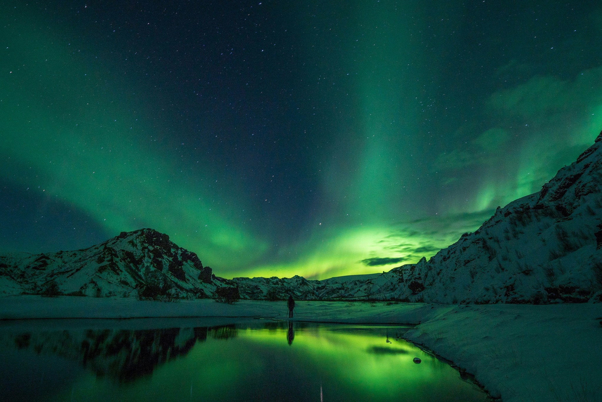 Northern lights reflecting on a lake in Iceland.
