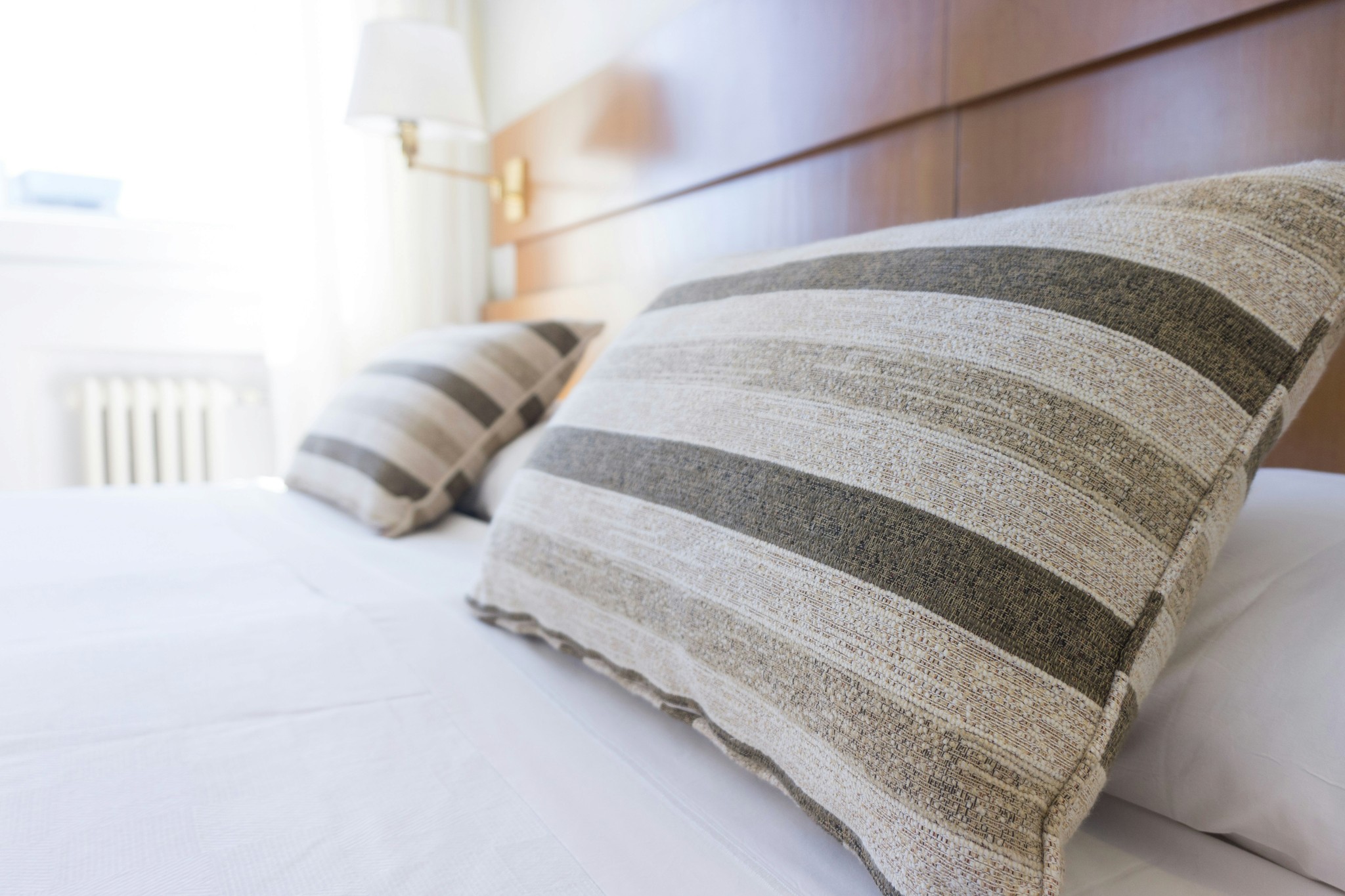 Comfy pillows arranged on a hotel bed.