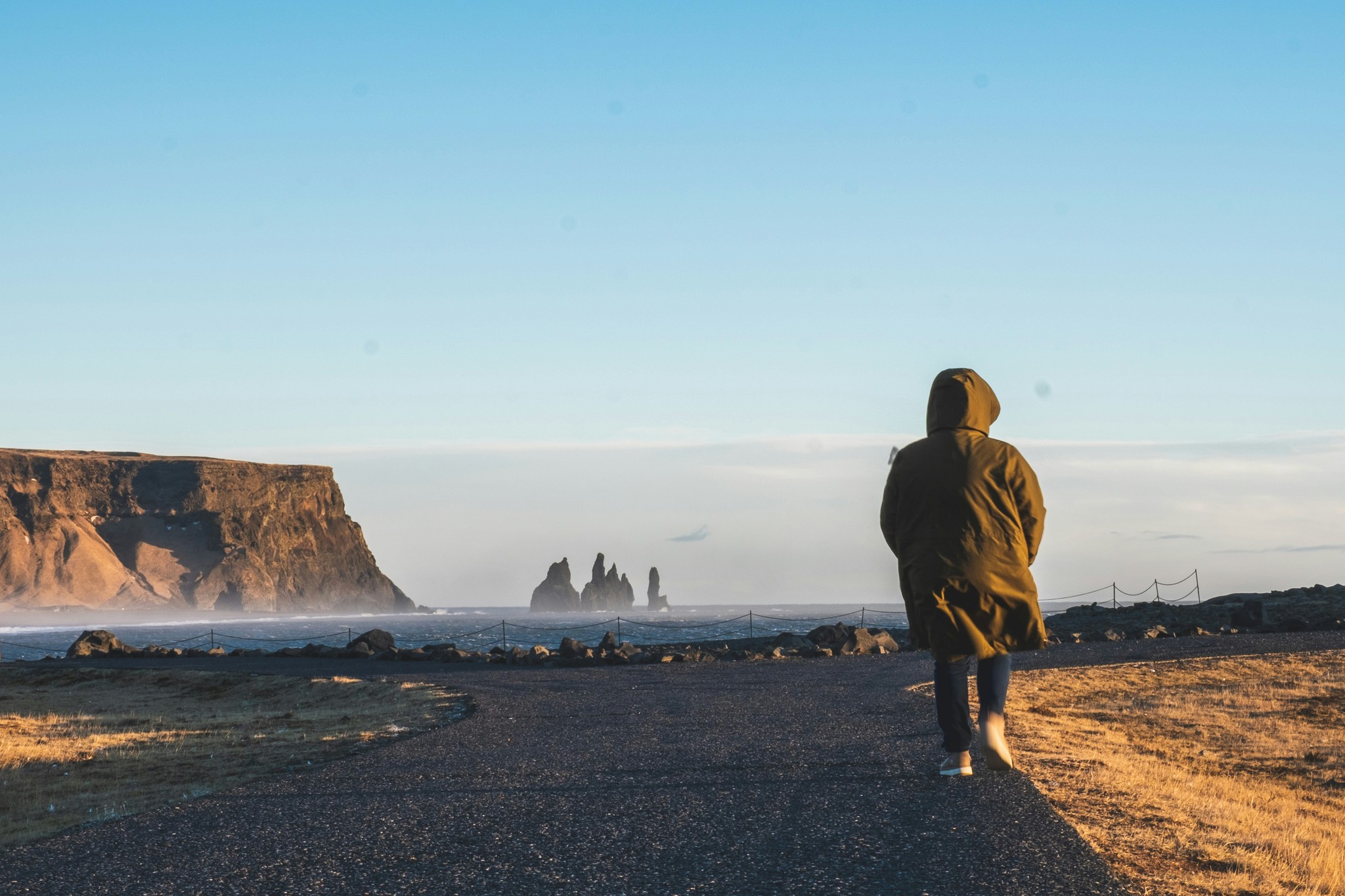 Tourist walking toward the Reynisfjara Viewpoint.