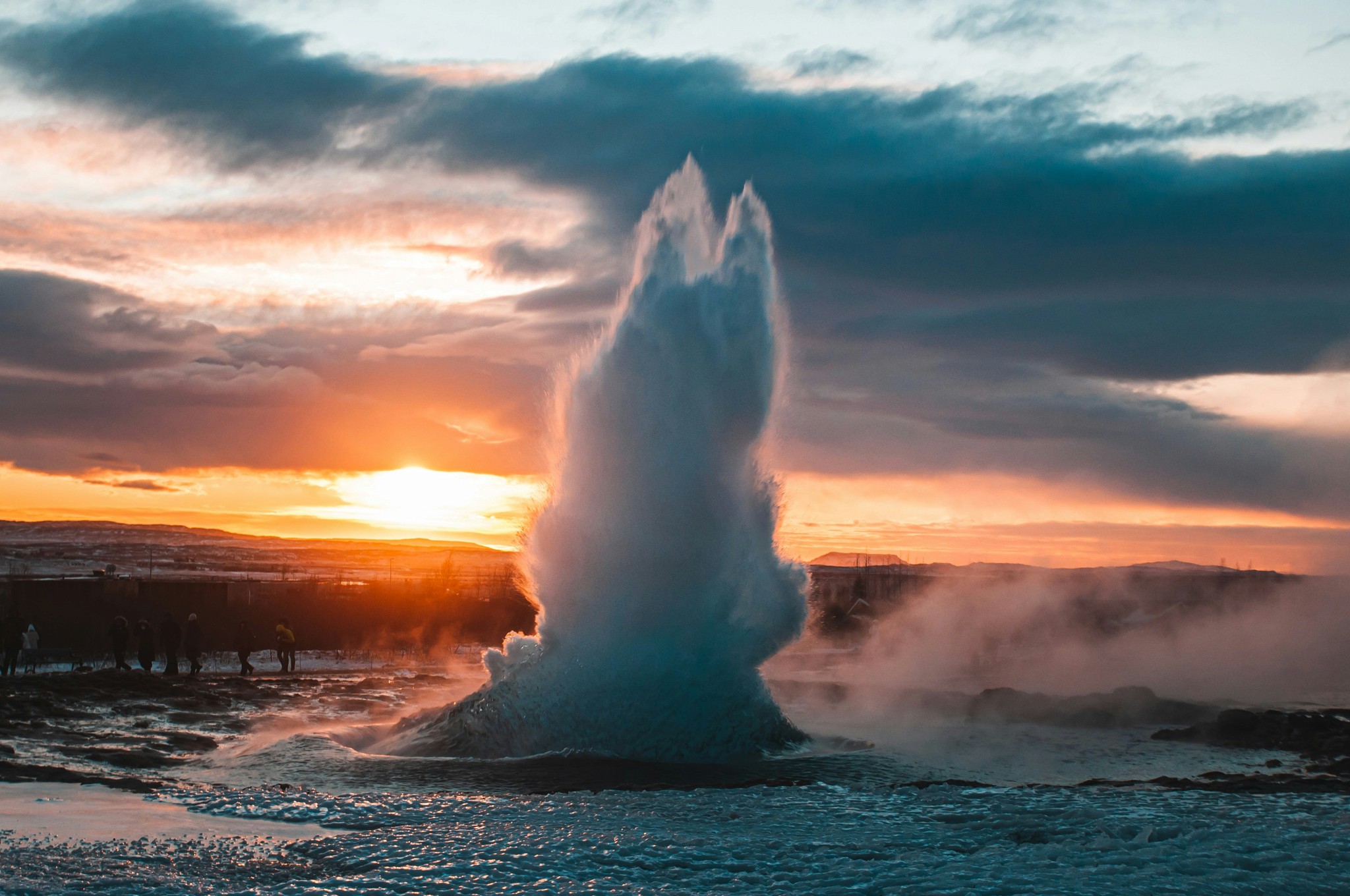 Geyser erupting at sunset on Iceland’s Golden Circle.