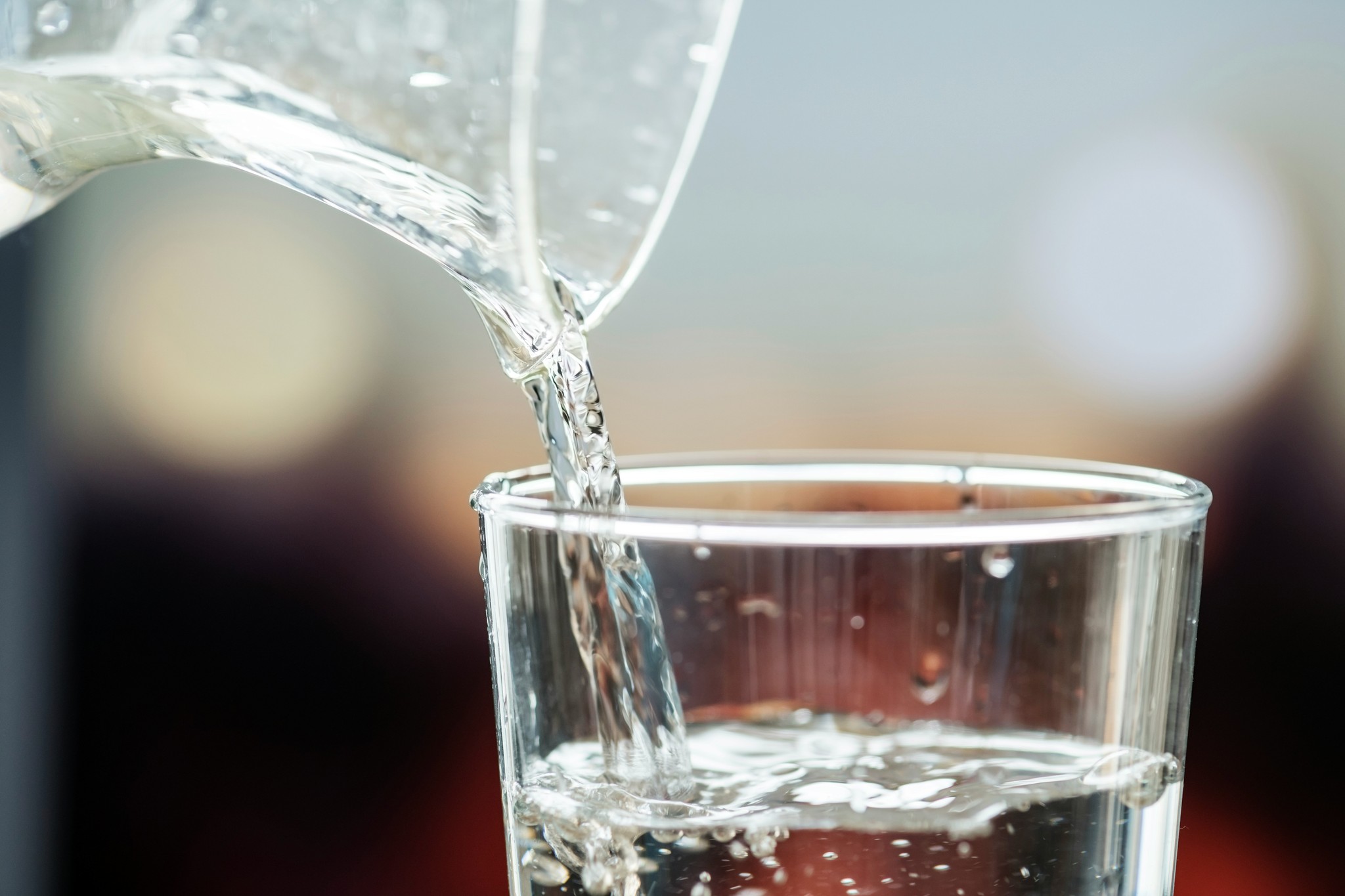 A glass being filled with water.