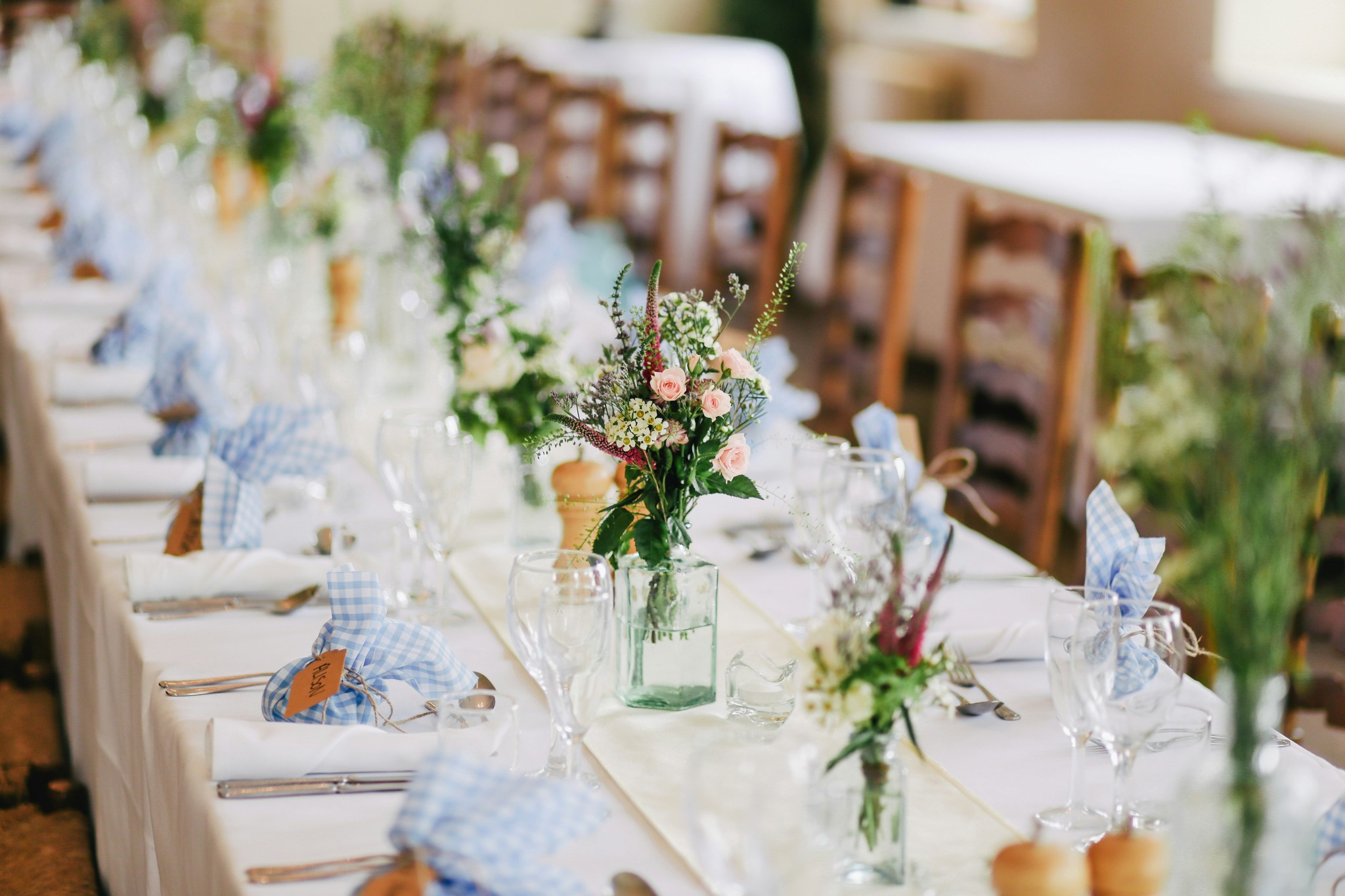 Wedding reception table with floral centerpieces.